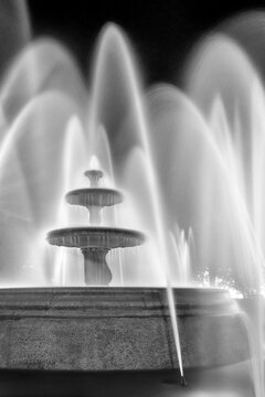 Black and white long exposure image of a park fountain at night