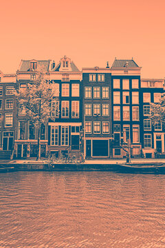 Iconic leaning houses with cian and sepia duotone filter in Amsterdam