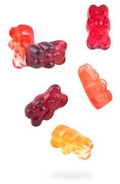 Translucent and colorful gummy bear candies levitation on a white background. Jelly beras falling in the air.