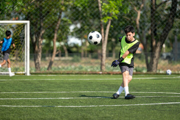 Obraz premium International school student practicing soccer dribbling