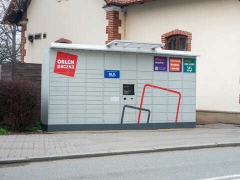 Poland - March 31, 2026: An ORLEN paczka parcel locker positioned on a street, providing convenient delivery and collection options for customers during modern urban life.