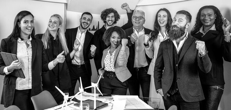 Horizontal banner with multiethnic joyful business people looking at camera inside corporate office for a group photo - Goal achievement concept - Black and white editing