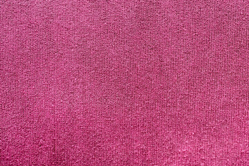 Fototapeta premium Dark pink fabric abstract background with detailed rough surface