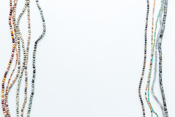 Naklejka premium Beads and necklaces of many gemstones and pearls, top view. Jewelry concept.