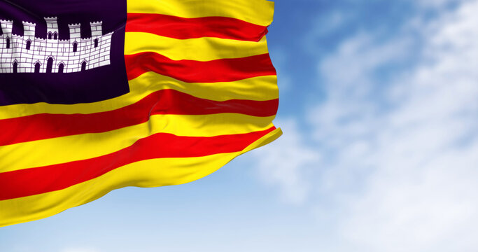 Balearic Islands flag waving in the wind on a clear day.