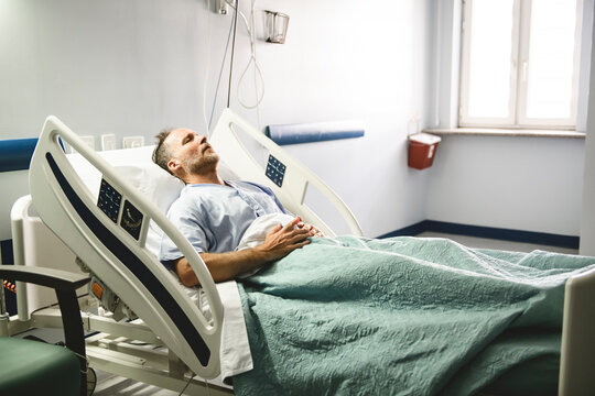 man in hospital bed suffering from cancer or other health problem