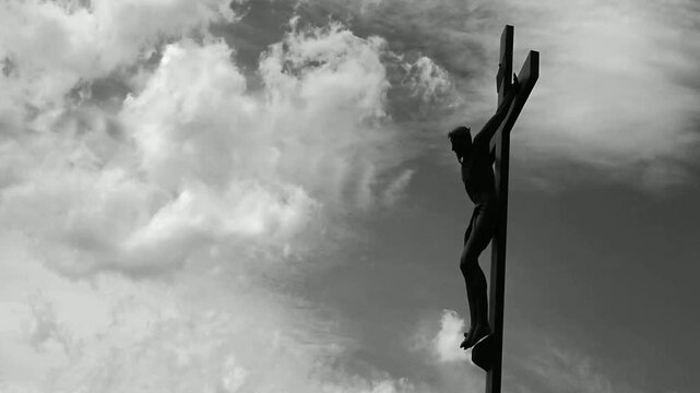 crucifix time lapse with running clouds, black and white