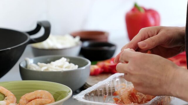Peeling Shrimps For Cooking In A Wok Pan In Kitchen