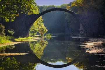 Foto auf Acrylglas Rakotzbrücke Rakotz Bridge (Devil's Bridge) in Kromlau Park with perfect reflection in water, Saxony, Germany  © Enrico Obergefäll