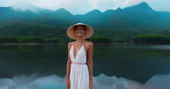 Serene Morning at Tra Ly Lake Woman in Traditional Vietnamese Hat