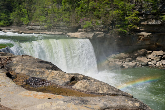 rainbow in the water by the waterfall