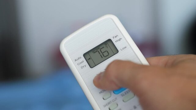 Turning Down Temperature on Thermostat in Summer in Hot Weather. Setting Digital Home Thermostat to Cool and Programming Air Conditioner. Adjusting Room Temperature to Energy Saving in Summer Heat.