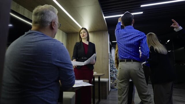 A business team experiences a heated conflict, with papers being thrown in a modern office. Professional colleagues face a stressful disagreement and chaotic scene during a project meeting.