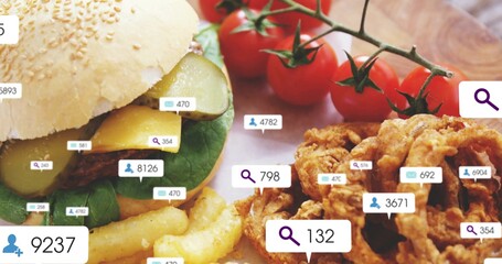 Showing sesame burger with cheddar, pickles on wood board, fries, onion rings, tomatoes, UI badges © vectorfusionart