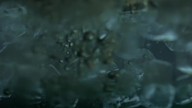 Close up of ice cubes underwater with oxygen bubbles, frost patterns, and soft light reflections. Concepts for beauty advertising, menu designs for bars and restaurants, cryotherapy.