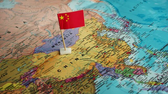 Hand places China flag on physical East Asia map