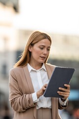 Businesswoman using digital tablet in urban setting © Zoran Jesic
