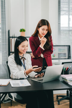 The female manager is training new employees in the office.