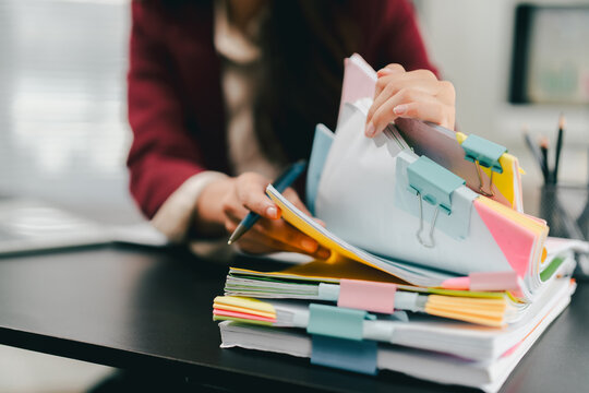 The female employees are working and searching for documents. The female accountant is preparing the company's annual taxes.