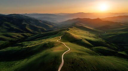 Aerial view of a winding river cutting through lush green countryside at dawn