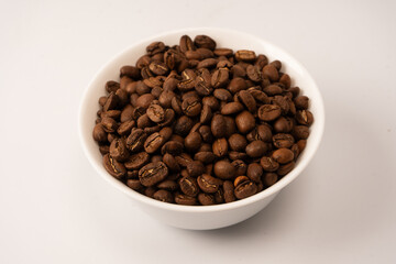 Fototapeta premium Coffee beans on a white background. Top view. Coffee beans texture.