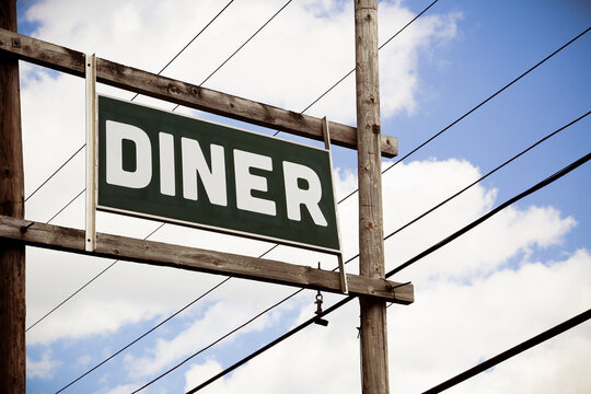 Vintage diner sign against blue sky