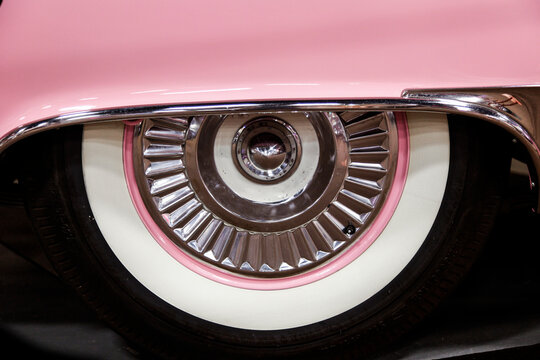 Close up of vintage car wheel with whitewall tire and chrome detail