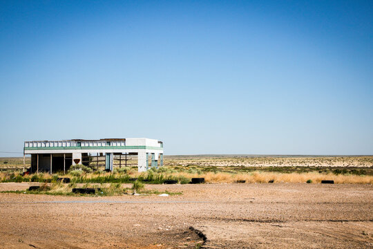 Abandoned roadside building in desert landscape along Route 66