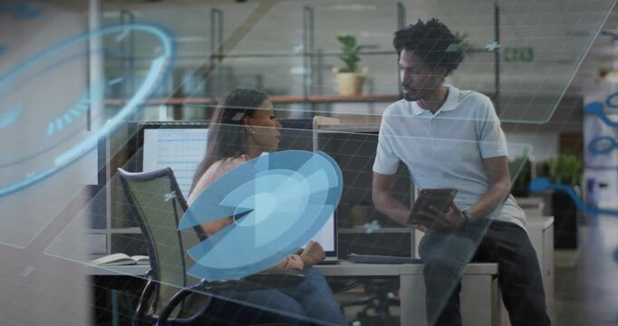 Woman pointing laptop initiating man reviewing tablet, office UI circle resizing obscuring subjects