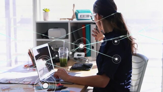 Woman typing, overlay linking laptop, shelf, causing reaching and grabbing red binder for design