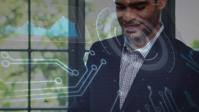 Tech exec tapping tablet, reviewing data by paned window, HUD charts and circuits growing over him
