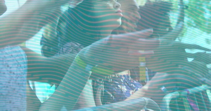 Front-row audience pressing rail and clapping, reacting to band playing while phones recording