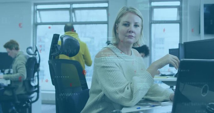 Woman typing, reacting to co-worker passing by chair, turning, smiling, tech overlay flooding scene