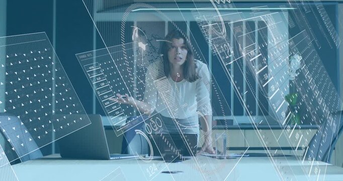 Woman leading business meeting starting slides on laptop and showing HUD graphs emphasizing metrics