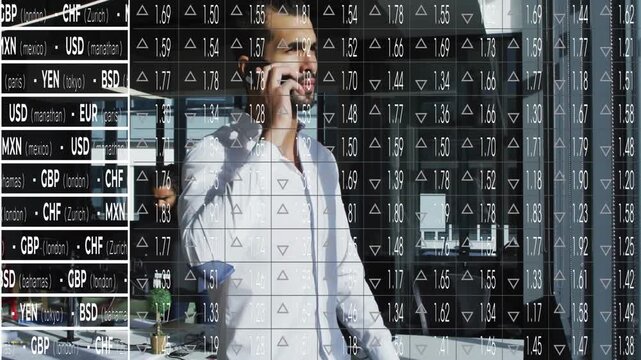 Businessman bringing phone to right ear, leaning on glass railing and monitoring currency overlay