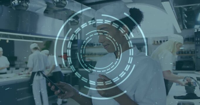 Vertical video: Female chef tapping smartphone causing HUD circling while checking order in kitchen