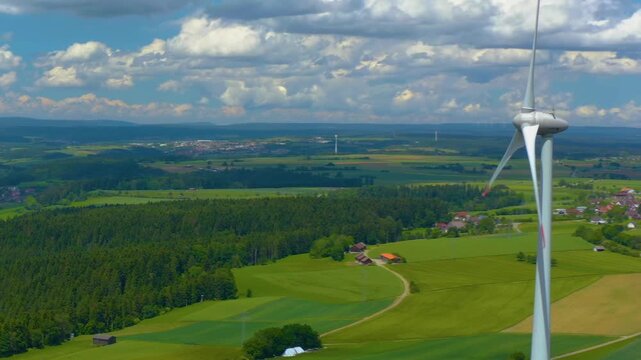 Aerial view of a wind turbine close to the Black Forest in Germany with a parallax  pan on a sunny day.