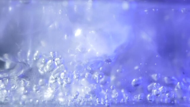 Close up of ice cubes underwater with oxygen bubbles, frost patterns, and soft light reflections. Concepts for beauty advertising, menu designs for bars and restaurants, cryotherapy.