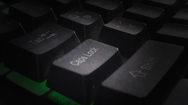 Hand on keyboard with Caps Lock is toggling on and off animation. Finger pressing Caps Lock on off command on the keyboard.