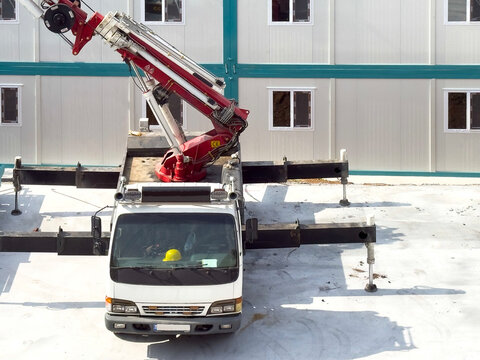 Construction crane beside prefabricated building site