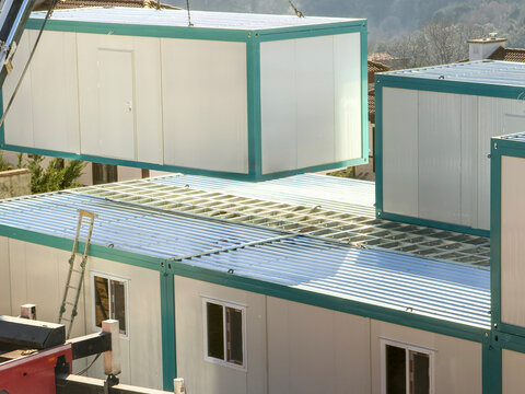 Prefabricated container units being assembled on site