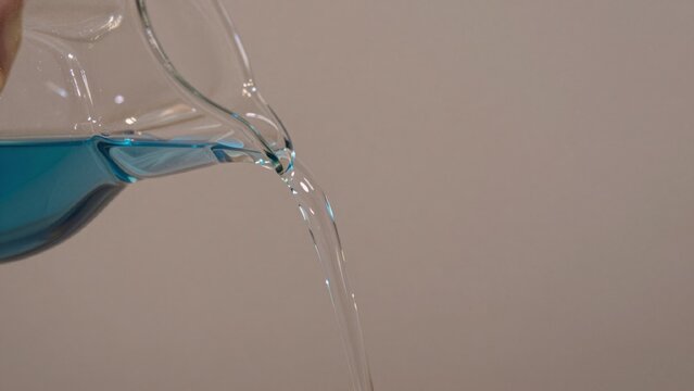 High resolution featuring close-up transparent glass pitcher filled blue liquid made clear oval-shaped has wid