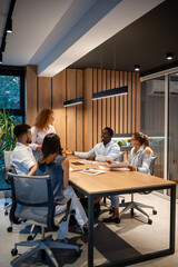 Diverse business team collaborating in modern office meeting © Zoran Jesic