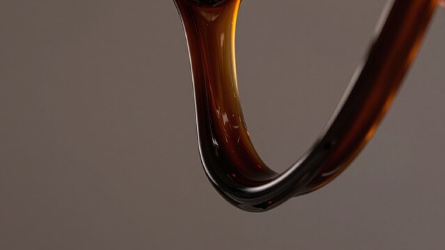 High-resolution featuring close-up curved amber-colored glass object appears made similar material glossy refl