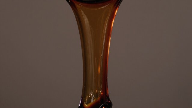 High-resolution featuring close-up glass vase appears made amber glossy reflective surface reflects light crea