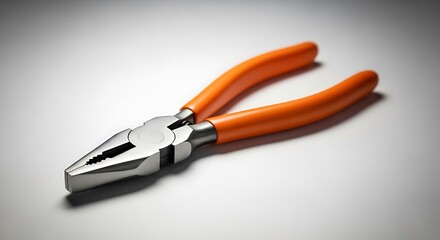Fototapeta premium High-quality metal pliers with orange insulated handles on clean background