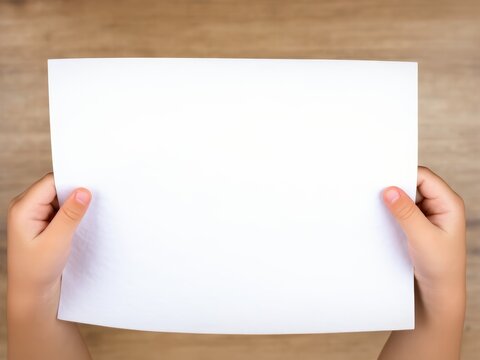 Child hands holding a blank, white A6 paper-landscape-orientation. 