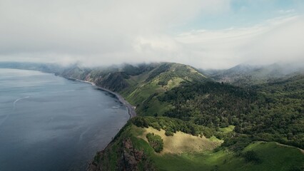 Vast oceanfront cliff edge offering panoramic views of rugged coastlines and rolling pastures © mstoylik