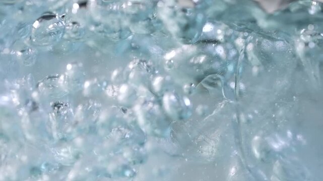 Close up of ice cubes underwater with oxygen bubbles, frost patterns, and soft light reflections. Concepts for beauty advertising, menu designs for bars and restaurants, cryotherapy.