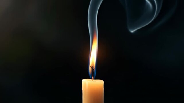 Single candle flame reigniting along a trail of smoke on a dark, blurred background
